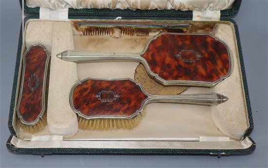 A cased plated and tortoiseshell brush set